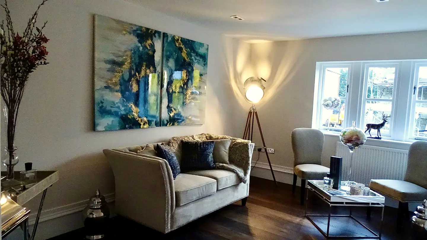 Show home lounge with teal abstract paintings