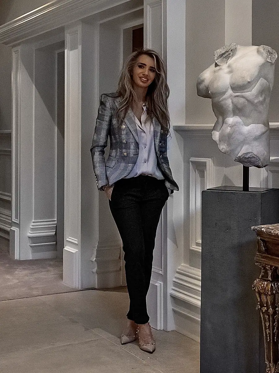 Dannielle Campbell in the entrance hall at Sandwarren, beside a marble torso sculpture